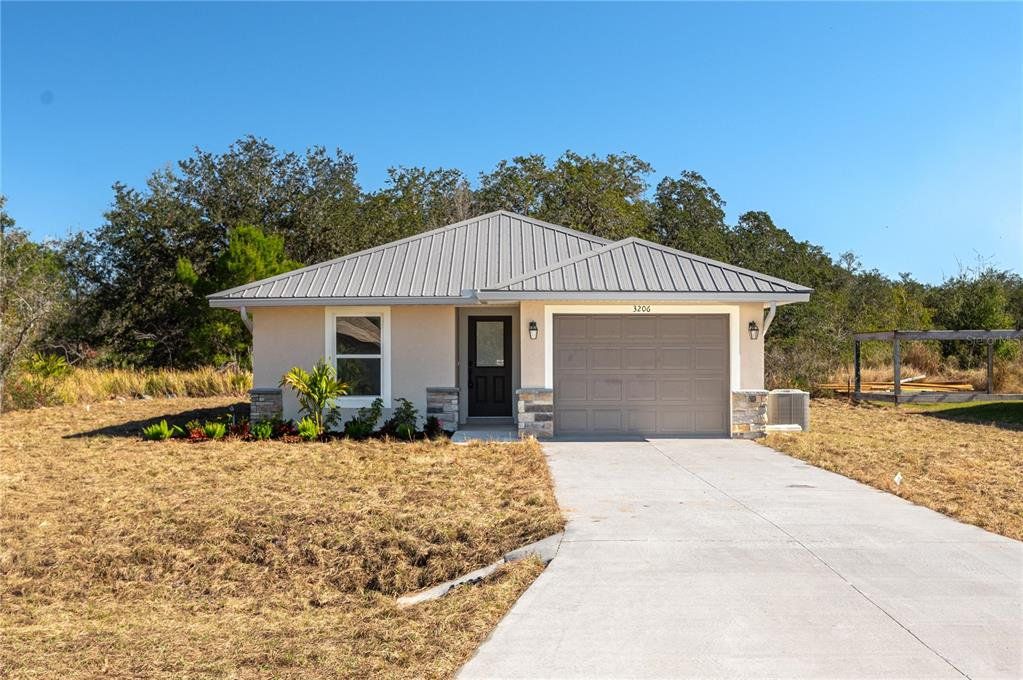 Front exterior of a new home in , Avon Park, FL, highlighting curb appeal (Image 1). Front exterior of a new home in , Avon Park, FL, highlighting curb appeal (Image 1).