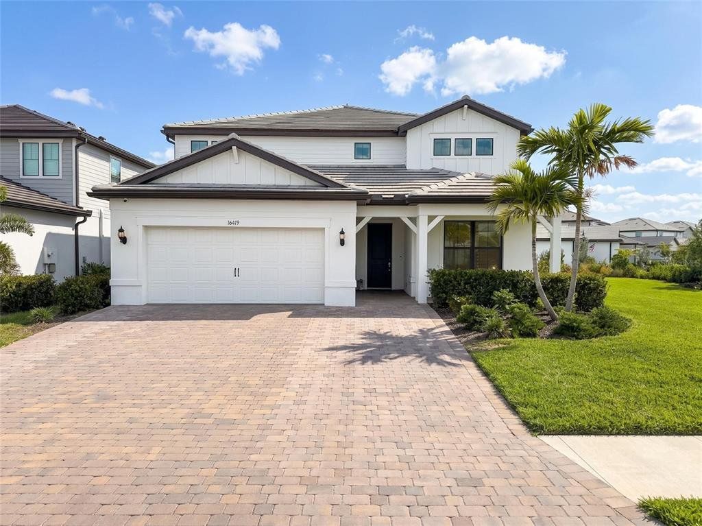Front exterior of a new home in Sapphire Point at Lakewood Ranch, Lakewood Ranch, FL, highlighting curb appeal (Image 1). Front exterior of a new home in Sapphire Point at Lakewood Ranch, Lakewood Ranch, FL, highlighting curb appeal (Image 1).
