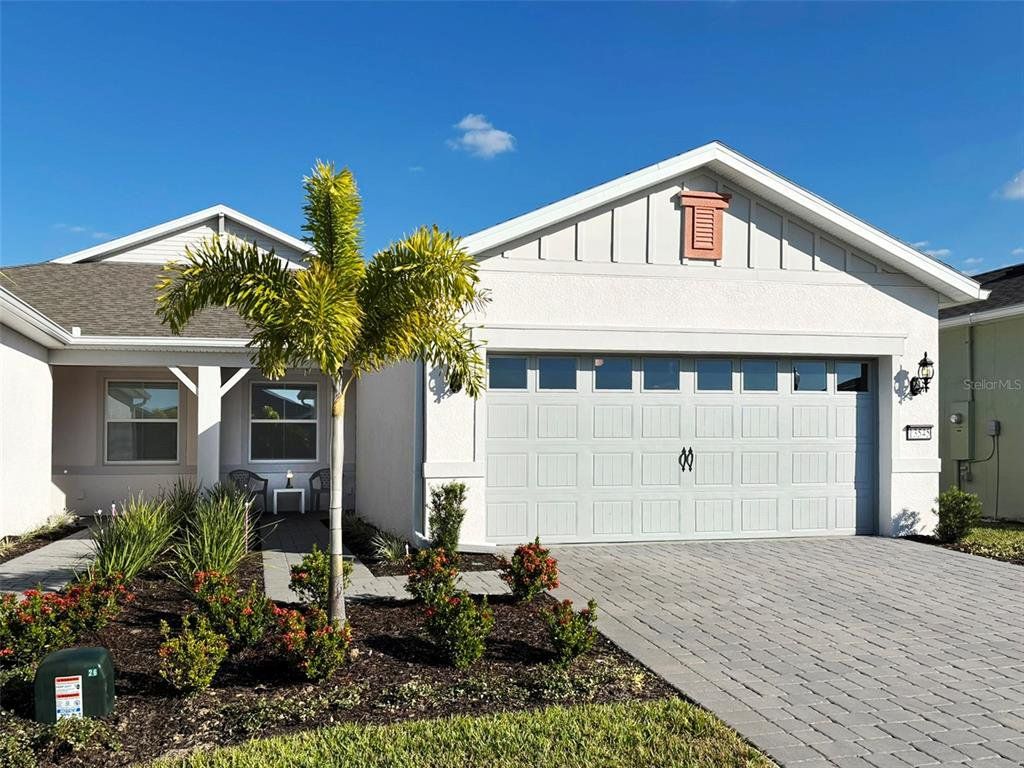Front exterior of a new home in Del Webb Oasis, Winter Garden, FL, highlighting curb appeal (Image 1). Front exterior of a new home in Del Webb Oasis, Winter Garden, FL, highlighting curb appeal (Image 1).