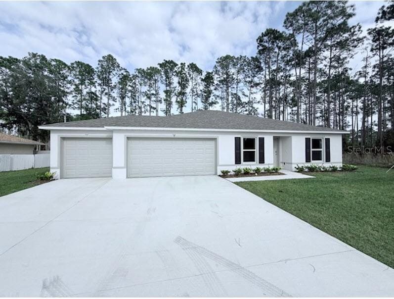 Front exterior of a new home in Palm Coast, Palm Coast, FL, highlighting curb appeal (Image 1). Front exterior of a new home in Palm Coast, Palm Coast, FL, highlighting curb appeal (Image 1).