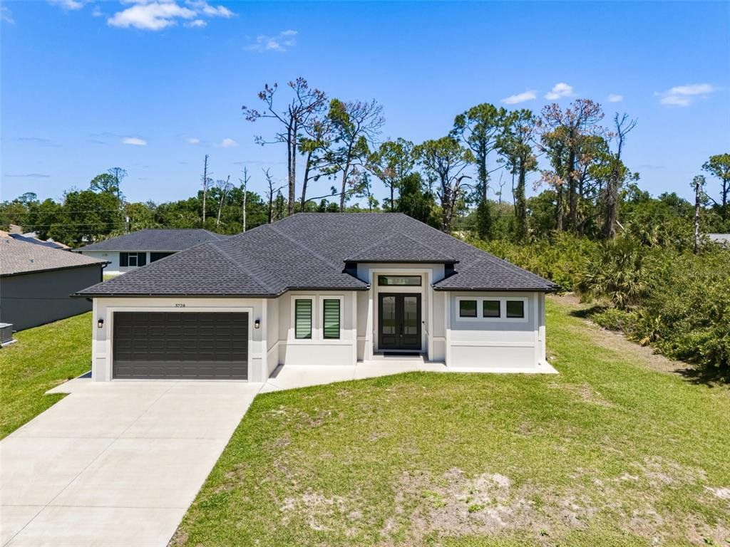 Front exterior of a new home in , North Port, FL, highlighting curb appeal (Image 1). Front exterior of a new home in , North Port, FL, highlighting curb appeal (Image 1).