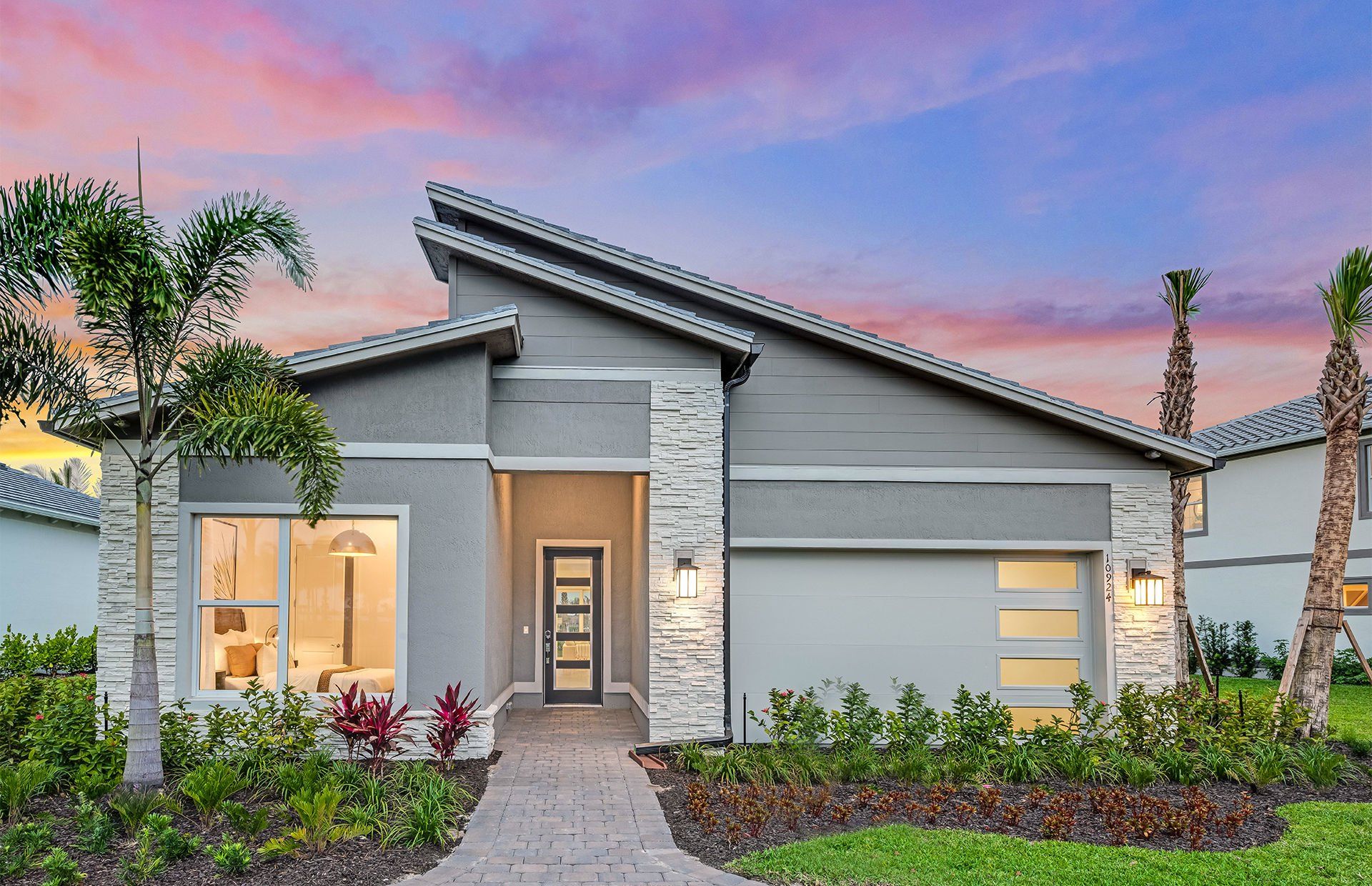 Front exterior of a new home in Avondale at Avenir, Palm Beach Gardens, FL, highlighting curb appeal (Image 1). Front exterior of a new home in Avondale at Avenir, Palm Beach Gardens, FL, highlighting curb appeal (Image 1).