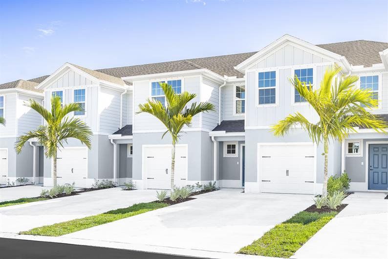 Front exterior of a new home in Terra Lago Townhomes, Indiantown, FL, highlighting curb appeal (Image 1). Front exterior of a new home in Terra Lago Townhomes, Indiantown, FL, highlighting curb appeal (Image 1).