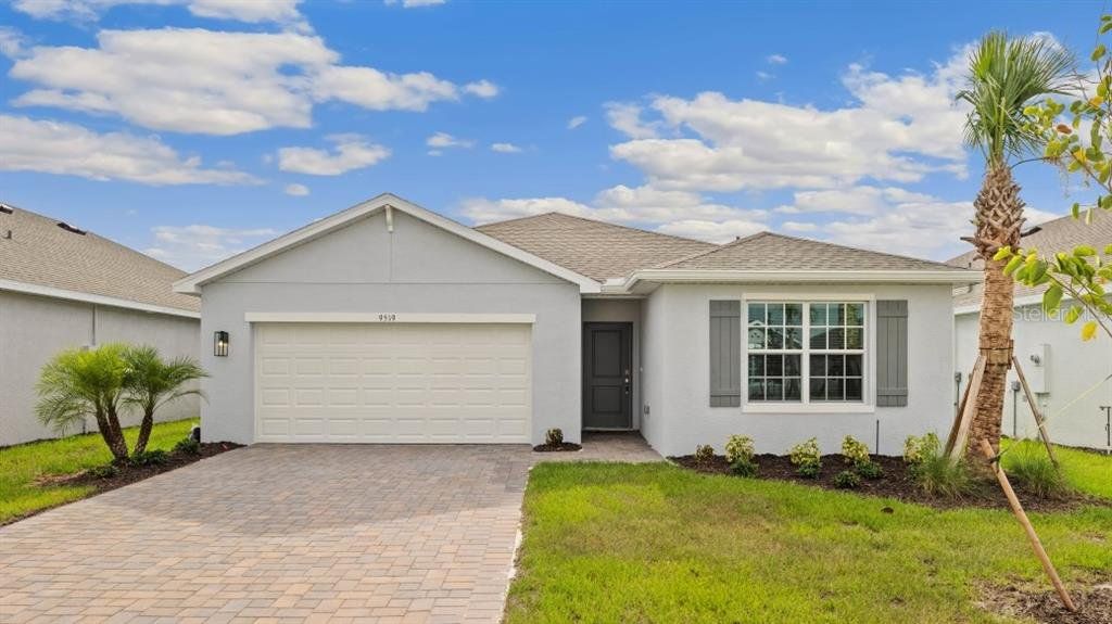 Front exterior of a new home in Coral Lakes - Tradition & Express, Punta Gorda, FL, highlighting curb appeal (Image 1). Front exterior of a new home in Coral Lakes - Tradition & Express, Punta Gorda, FL, highlighting curb appeal (Image 1).