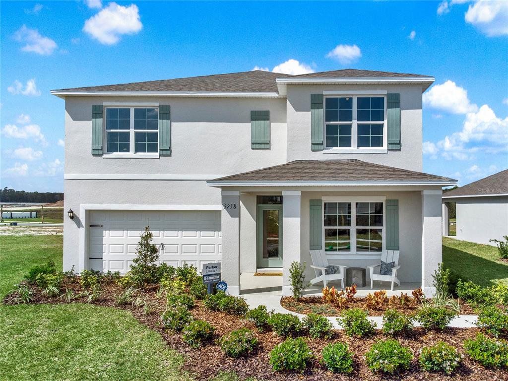 Front exterior of a new home in Windrose, Apopka, FL, highlighting curb appeal (Image 1). Front exterior of a new home in Windrose, Apopka, FL, highlighting curb appeal (Image 1).
