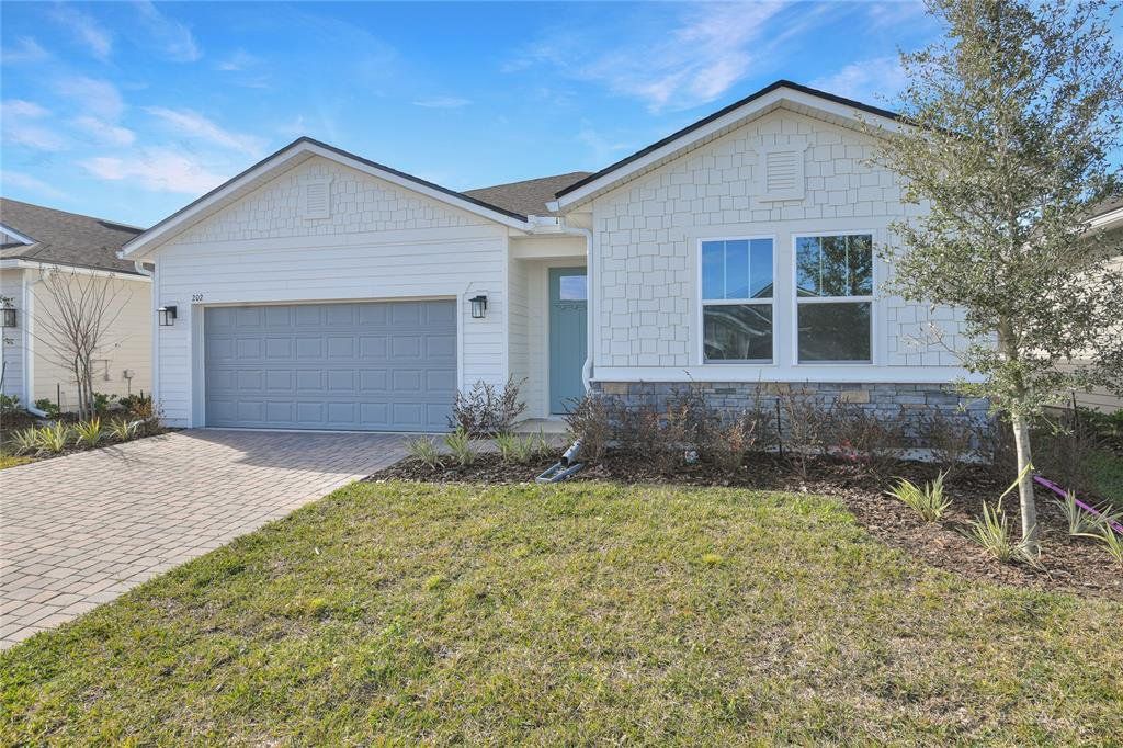 Front exterior of a new home in Seminole Palms, Palm Coast, FL, highlighting curb appeal (Image 1). Front exterior of a new home in Seminole Palms, Palm Coast, FL, highlighting curb appeal (Image 1).