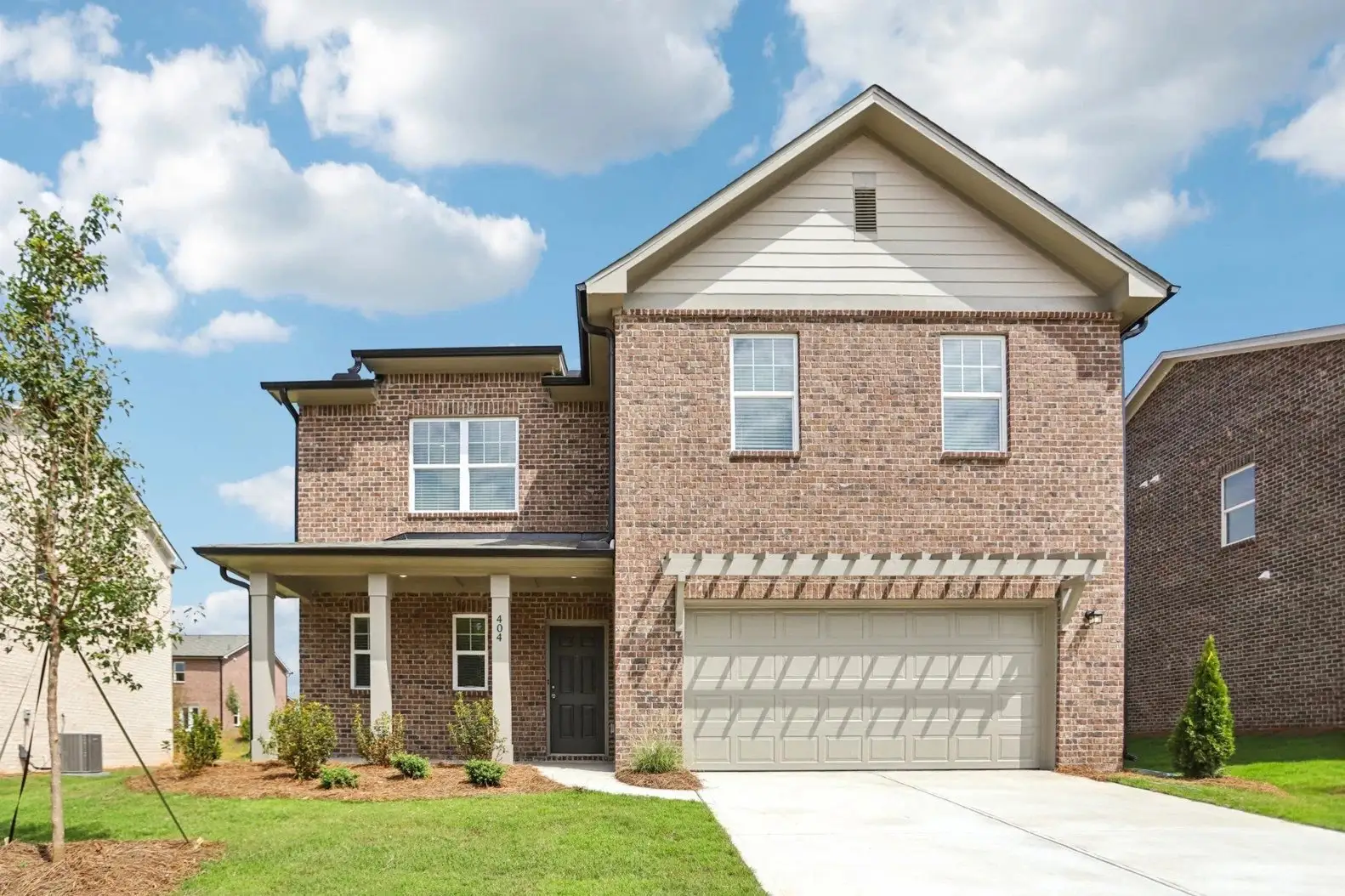Front exterior of a new home in Kendall Grove, McDonough, GA, highlighting curb appeal (Image 1). Front exterior of a new home in Kendall Grove, McDonough, GA, highlighting curb appeal (Image 1).