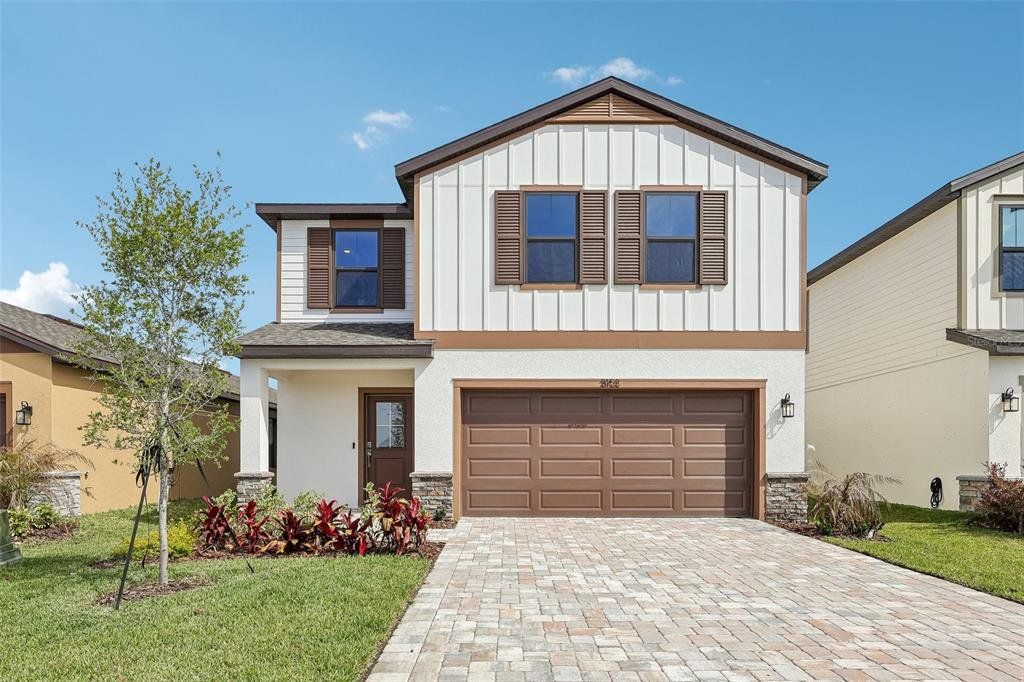 Front exterior of a new home in Grasslands West, Lakeland, FL, highlighting curb appeal (Image 1). Front exterior of a new home in Grasslands West, Lakeland, FL, highlighting curb appeal (Image 1).