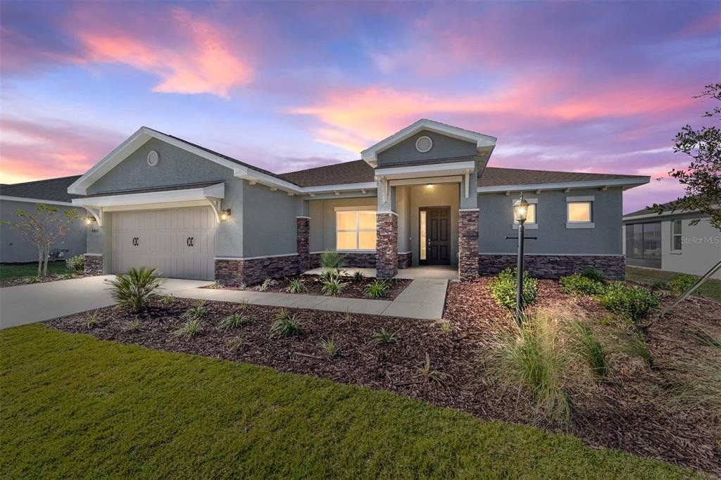 Front exterior of a new home in On Top of the World Communities, Ocala, FL, highlighting curb appeal (Image 1). Front exterior of a new home in On Top of the World Communities, Ocala, FL, highlighting curb appeal (Image 1).