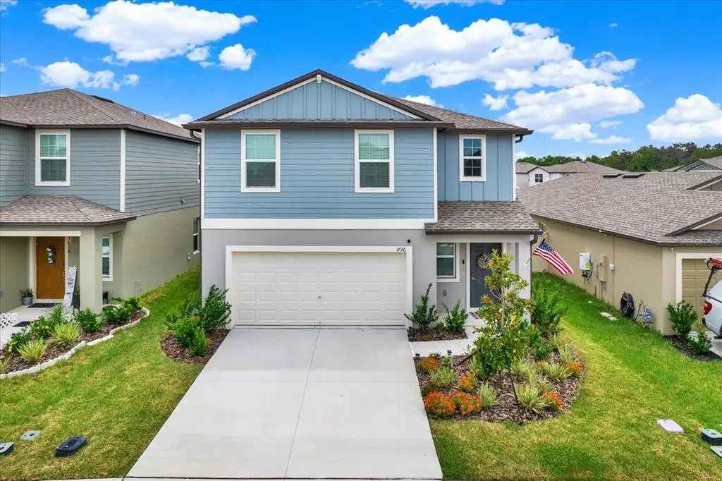 Front exterior of a new home in Two Rivers, Zephyrhills, FL, highlighting curb appeal (Image 1). Front exterior of a new home in Two Rivers, Zephyrhills, FL, highlighting curb appeal (Image 1).