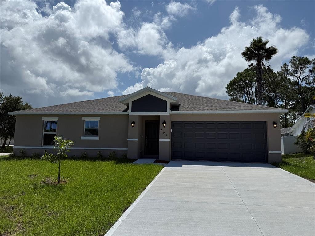 Front exterior of a new home in , Palm Bay, FL, highlighting curb appeal (Image 1). Front exterior of a new home in , Palm Bay, FL, highlighting curb appeal (Image 1).