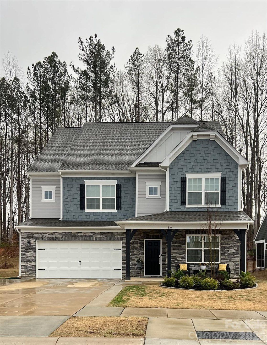 Front exterior of a new home in Falls Cove at Lake Norman, Troutman, NC, highlighting curb appeal (Image 1). Front exterior of a new home in Falls Cove at Lake Norman, Troutman, NC, highlighting curb appeal (Image 1).