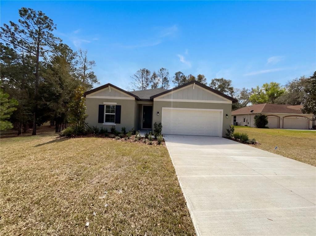Front exterior of a new home in Grand Park, Dunnellon, FL, highlighting curb appeal (Image 1). Front exterior of a new home in Grand Park, Dunnellon, FL, highlighting curb appeal (Image 1).