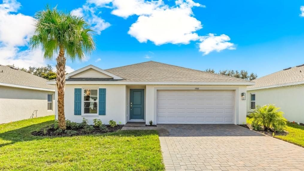 Front exterior of a new home in Central Parc, North Port, FL, highlighting curb appeal (Image 1). Front exterior of a new home in Central Parc, North Port, FL, highlighting curb appeal (Image 1).