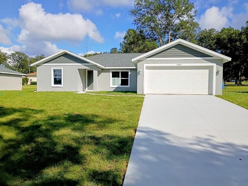 Front exterior of a new home in , Summerfield, FL, highlighting curb appeal (Image 1). Front exterior of a new home in , Summerfield, FL, highlighting curb appeal (Image 1).
