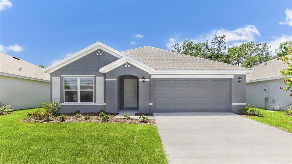 Front exterior of a new home in Oakfield Lakes, Parrish, FL, highlighting curb appeal (Image 1).
