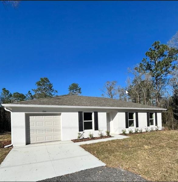 Front exterior of a new home in Flagler Estates, Hastings, FL, highlighting curb appeal (Image 1). Front exterior of a new home in Flagler Estates, Hastings, FL, highlighting curb appeal (Image 1).