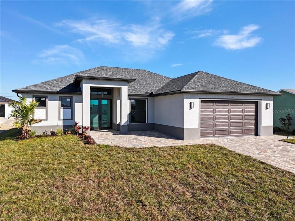 Front exterior of a new home in , Cape Coral, FL, highlighting curb appeal (Image 1). Front exterior of a new home in , Cape Coral, FL, highlighting curb appeal (Image 1).