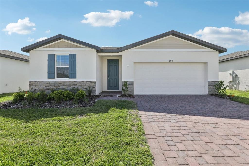 Front exterior of a new home in Lawson Dunes - Signature Series, Haines City, FL, highlighting curb appeal (Image 1). Front exterior of a new home in Lawson Dunes - Signature Series, Haines City, FL, highlighting curb appeal (Image 1).
