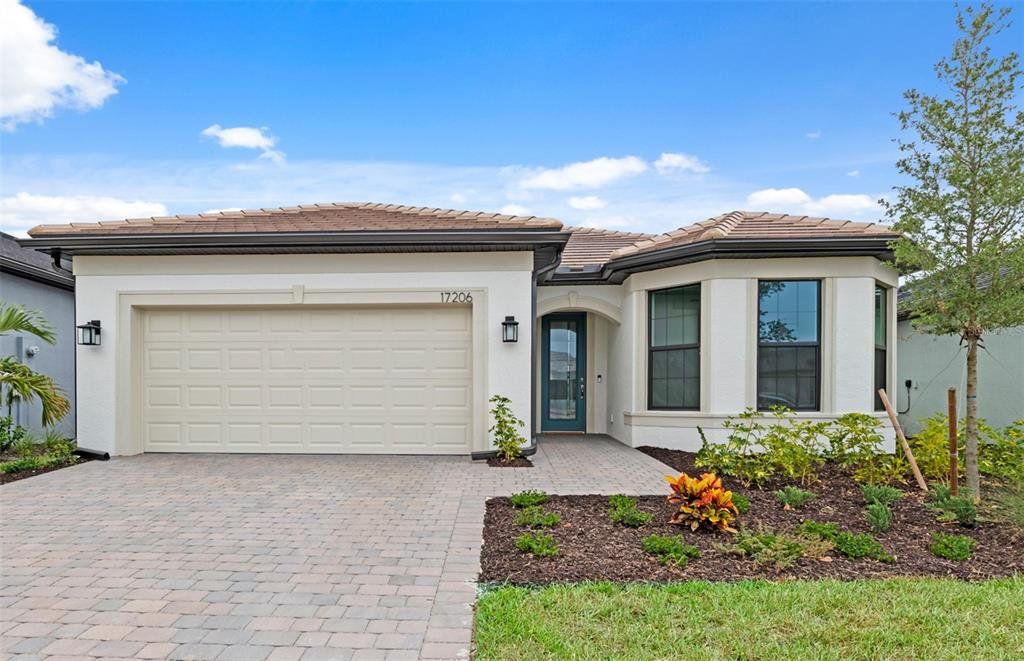Front exterior of a new home in Lakespur Wellen Park, Venice, FL, highlighting curb appeal (Image 1). Front exterior of a new home in Lakespur Wellen Park, Venice, FL, highlighting curb appeal (Image 1).