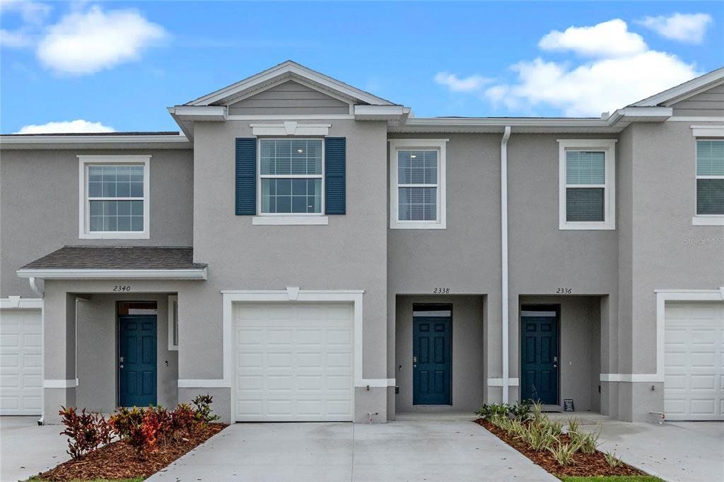 Front exterior of a new home in Preston Cove, St. Cloud, FL, highlighting curb appeal (Image 1).