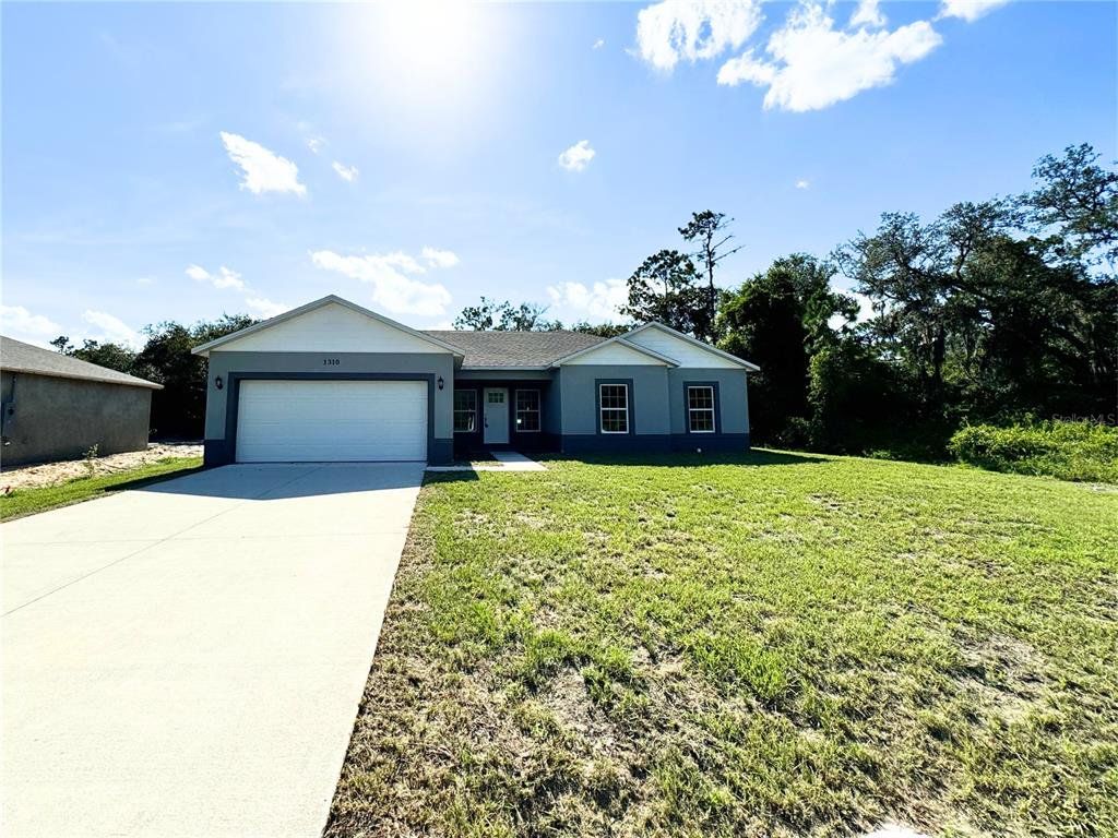 Front exterior of a new home in , Poinciana, FL, highlighting curb appeal (Image 1). Front exterior of a new home in , Poinciana, FL, highlighting curb appeal (Image 1).