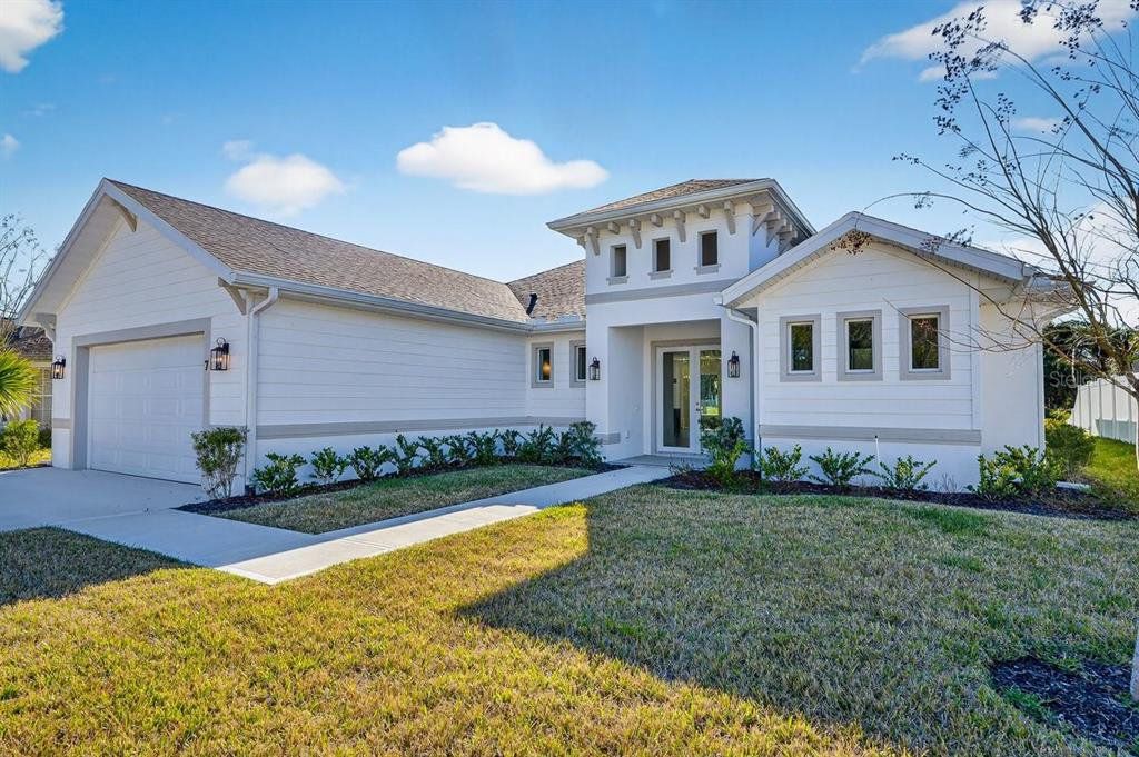 Front exterior of a new home in , Palm Coast, FL, highlighting curb appeal (Image 1). Front exterior of a new home in , Palm Coast, FL, highlighting curb appeal (Image 1).