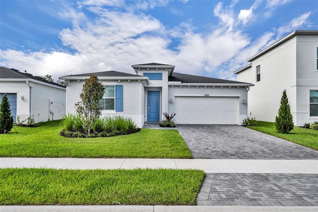 Front exterior of a new home in Riverwood at Everlands: The Angler Collection, Palm Bay, FL, highlighting curb appeal (Image 1). Front exterior of a new home in Riverwood at Everlands: The Angler Collection, Palm Bay, FL, highlighting curb appeal (Image 1).