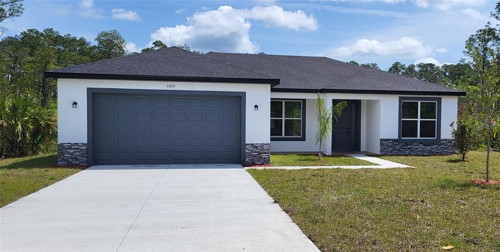 Front exterior of a new home in , Bunnell, FL, highlighting curb appeal (Image 1). Front exterior of a new home in , Bunnell, FL, highlighting curb appeal (Image 1).