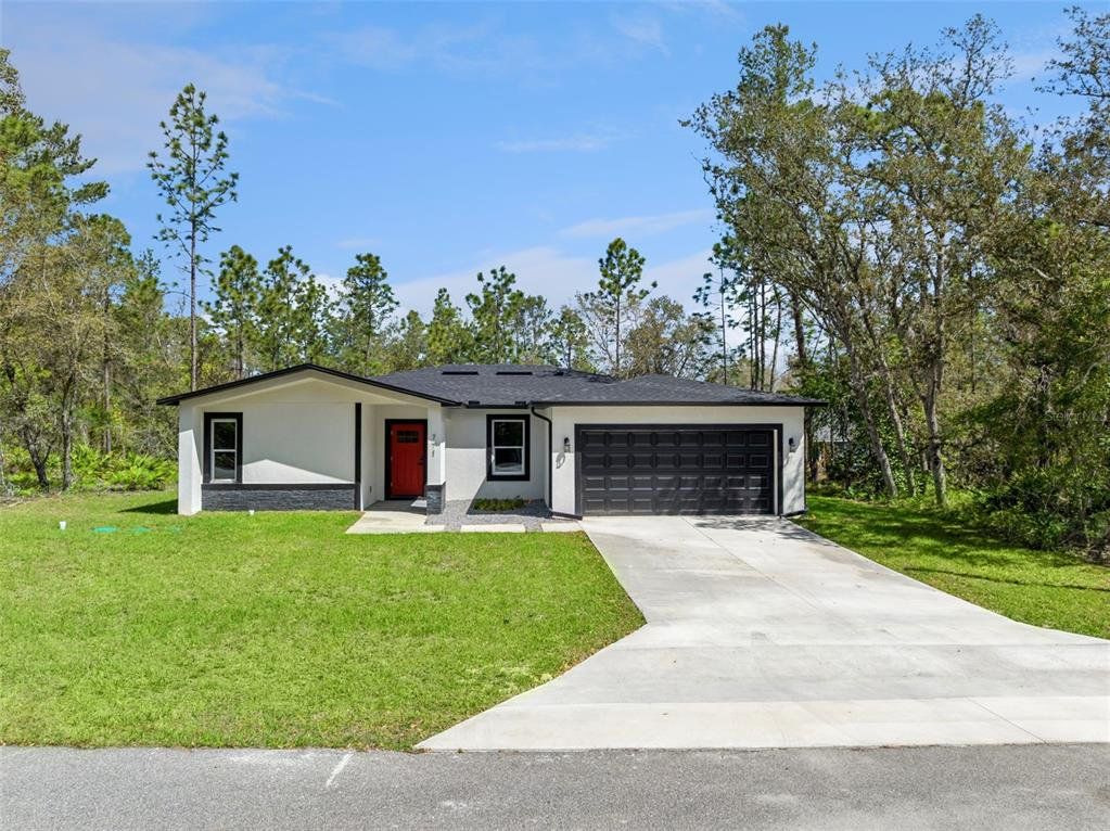 Front exterior of a new home in , Citrus Springs, FL, highlighting curb appeal (Image 1). Front exterior of a new home in , Citrus Springs, FL, highlighting curb appeal (Image 1).