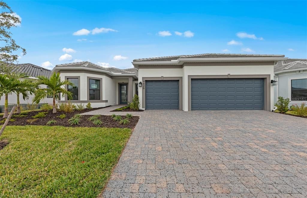 Front exterior of a new home in Del Webb Catalina, Lakewood Ranch, FL, highlighting curb appeal (Image 1). Front exterior of a new home in Del Webb Catalina, Lakewood Ranch, FL, highlighting curb appeal (Image 1).