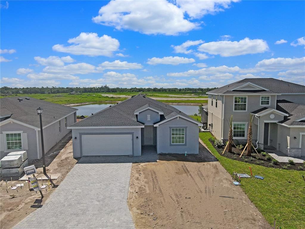 Front exterior of a new home in Lennar at Turnleaf: Executive Homes, Punta Gorda, FL, highlighting curb appeal (Image 1).