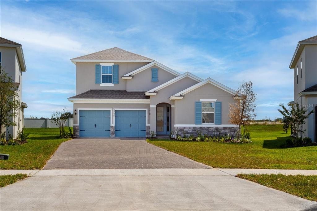 Front exterior of a new home in Hamlin Meadows, Winter Garden, FL, highlighting curb appeal (Image 1). Front exterior of a new home in Hamlin Meadows, Winter Garden, FL, highlighting curb appeal (Image 1).