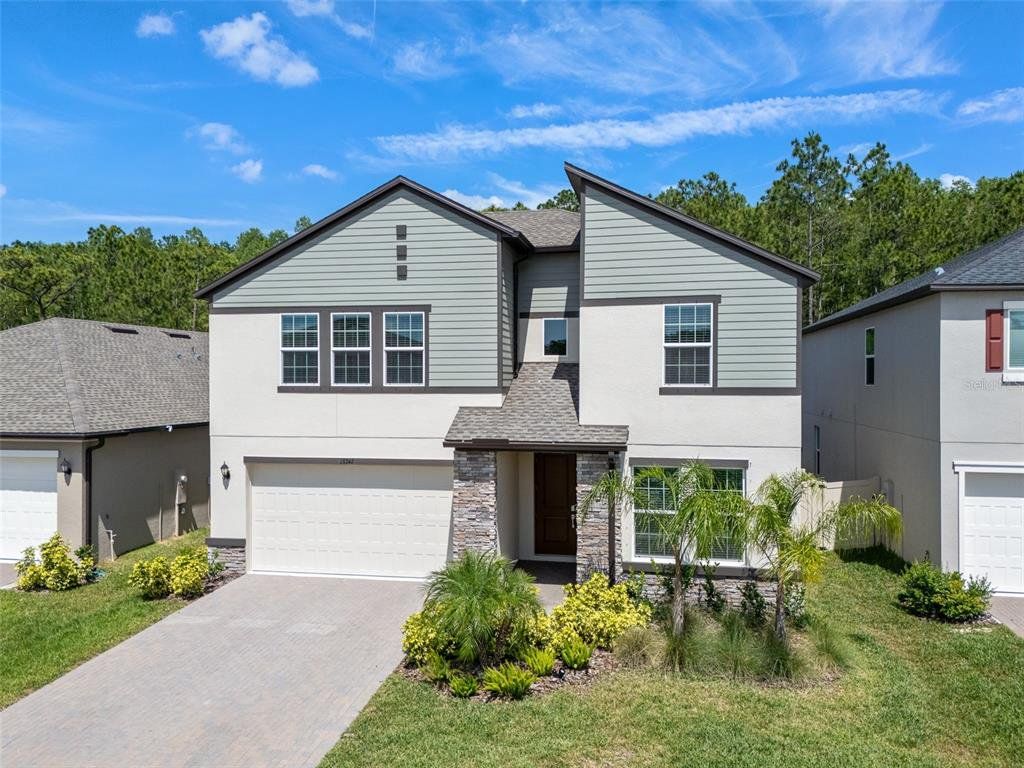 Front exterior of a new home in , Lutz, FL, highlighting curb appeal (Image 1). Front exterior of a new home in , Lutz, FL, highlighting curb appeal (Image 1).
