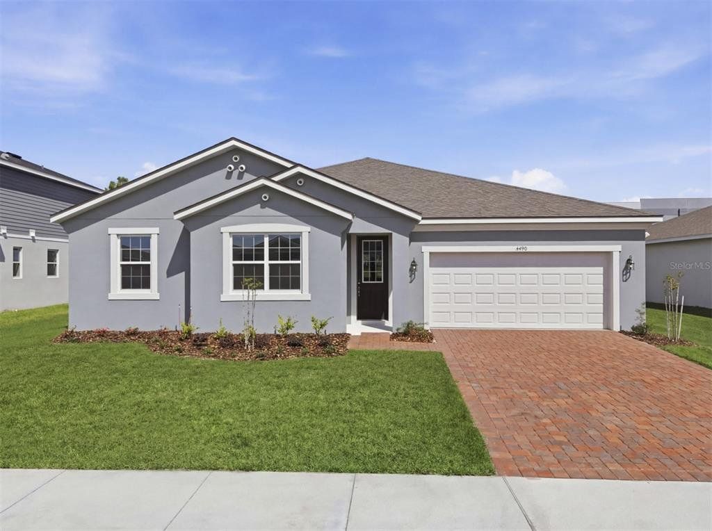 Front exterior of a new home in Meadowlark Landing, Apopka, FL, highlighting curb appeal (Image 1). Front exterior of a new home in Meadowlark Landing, Apopka, FL, highlighting curb appeal (Image 1).