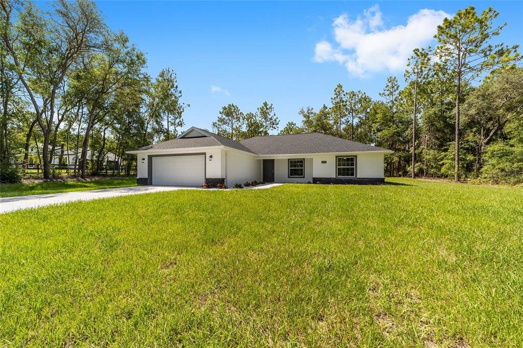 Front exterior of a new home in , Ocala, FL, highlighting curb appeal (Image 1). Front exterior of a new home in , Ocala, FL, highlighting curb appeal (Image 1).