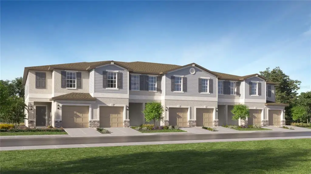 Front exterior of a new home in Townes at Southshore Pointe, Ruskin, FL, highlighting curb appeal (Image 1).