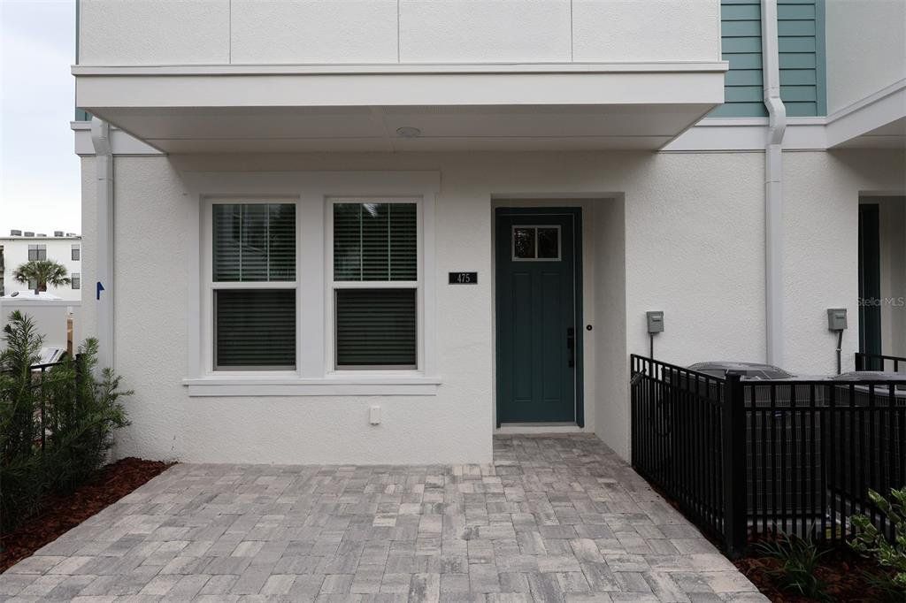 Front exterior of a new home in Towns at Union, St. Petersburg, FL, highlighting curb appeal (Image 1). Front exterior of a new home in Towns at Union, St. Petersburg, FL, highlighting curb appeal (Image 1).