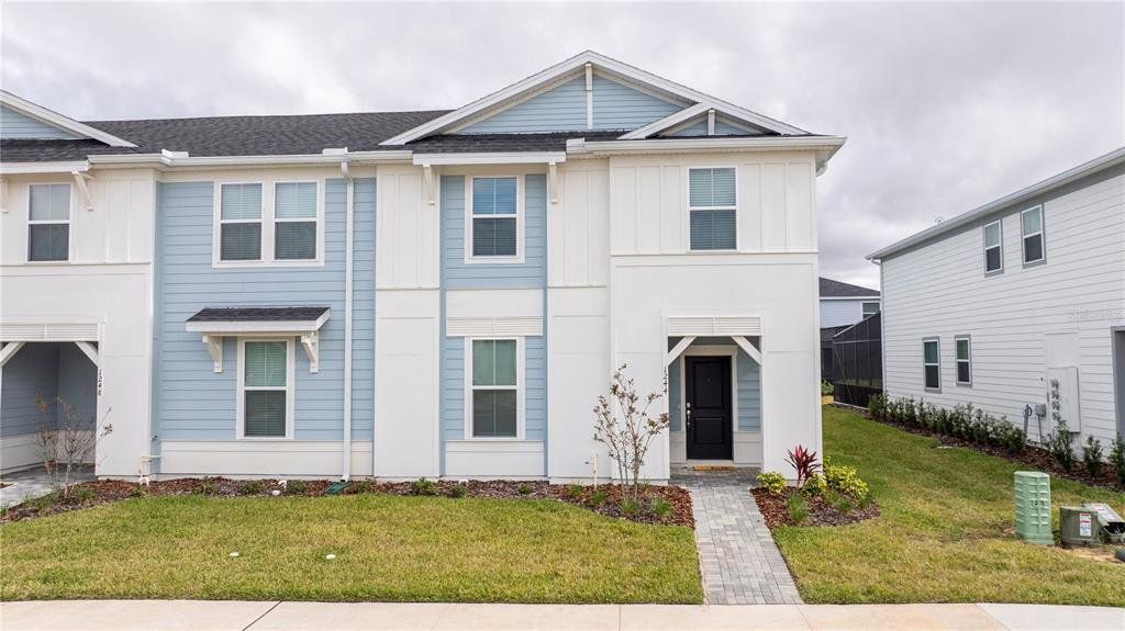 Front exterior of a new home in Windsor Cay Resort, Clermont, FL, highlighting curb appeal (Image 1). Front exterior of a new home in Windsor Cay Resort, Clermont, FL, highlighting curb appeal (Image 1).