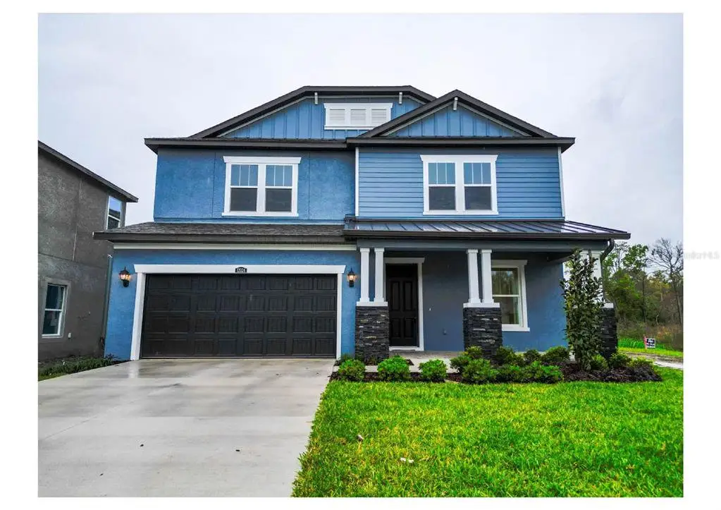 Front exterior of a new home in , Tampa, FL, highlighting curb appeal (Image 1). Front exterior of a new home in , Tampa, FL, highlighting curb appeal (Image 1).