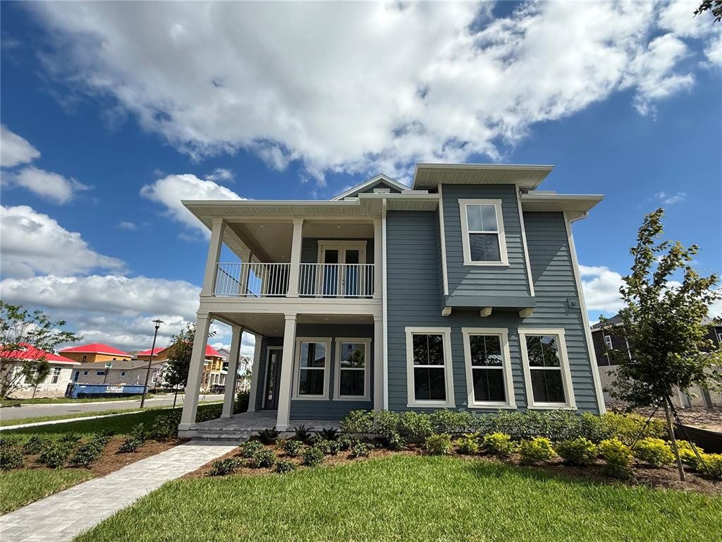 Front exterior of a new home in Laureate Park, Orlando, FL, highlighting curb appeal (Image 1). Front exterior of a new home in Laureate Park, Orlando, FL, highlighting curb appeal (Image 1).