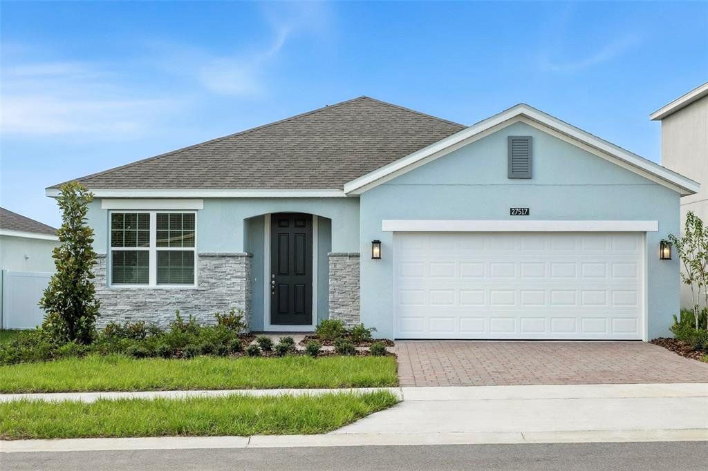 Front exterior of a new home in Eagletail Landings, Howey-in-the-Hills, FL, highlighting curb appeal (Image 1). Front exterior of a new home in Eagletail Landings, Howey-in-the-Hills, FL, highlighting curb appeal (Image 1).