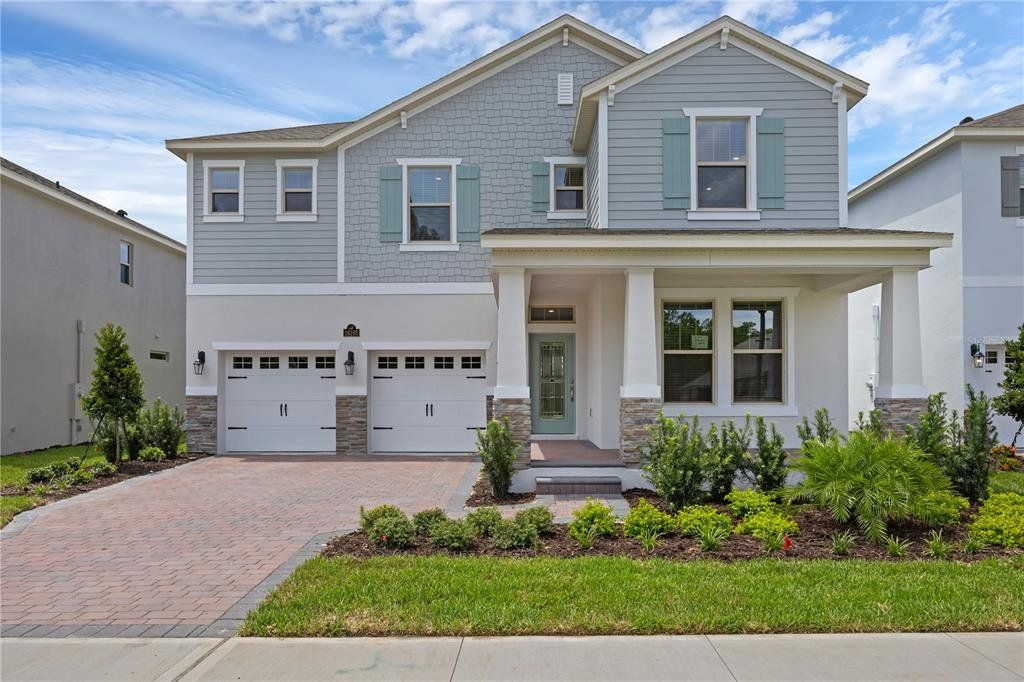 Front exterior of a new home in Waterleigh, Winter Garden, FL, highlighting curb appeal (Image 1). Front exterior of a new home in Waterleigh, Winter Garden, FL, highlighting curb appeal (Image 1).