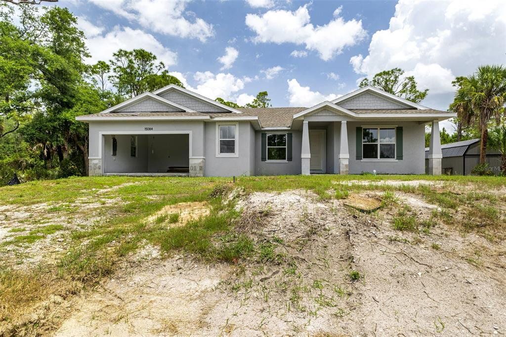 Front exterior of a new home in , Port Charlotte, FL, highlighting curb appeal (Image 1). Front exterior of a new home in , Port Charlotte, FL, highlighting curb appeal (Image 1).