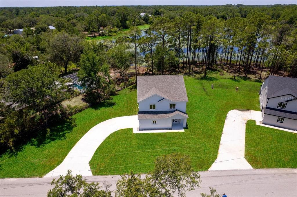 Front exterior of a new home in , Deltona, FL, highlighting curb appeal (Image 1). Front exterior of a new home in , Deltona, FL, highlighting curb appeal (Image 1).