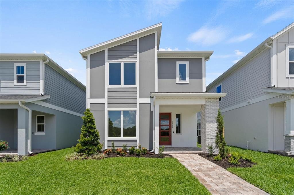 Front exterior of a new home in Trinity Place, St. Cloud, FL, highlighting curb appeal (Image 1).