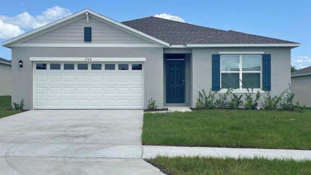 Front exterior of a new home in Tradewinds at Hammock Reserve, Haines City, FL, highlighting curb appeal (Image 1). Front exterior of a new home in Tradewinds at Hammock Reserve, Haines City, FL, highlighting curb appeal (Image 1).