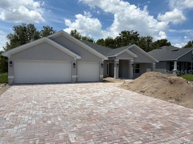 Front exterior of a new home in Juliette Falls, Dunnellon, FL, highlighting curb appeal (Image 1). Front exterior of a new home in Juliette Falls, Dunnellon, FL, highlighting curb appeal (Image 1).