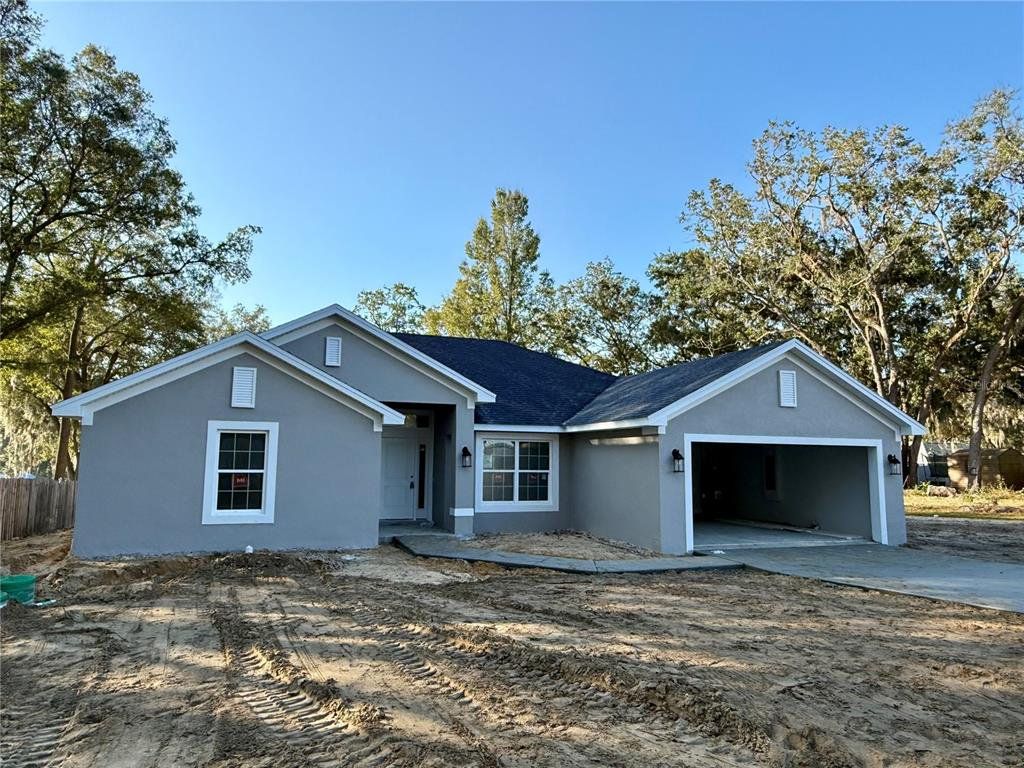 Front exterior of a new home in Orange Blossom Hills, Summerfield, FL, highlighting curb appeal (Image 1).