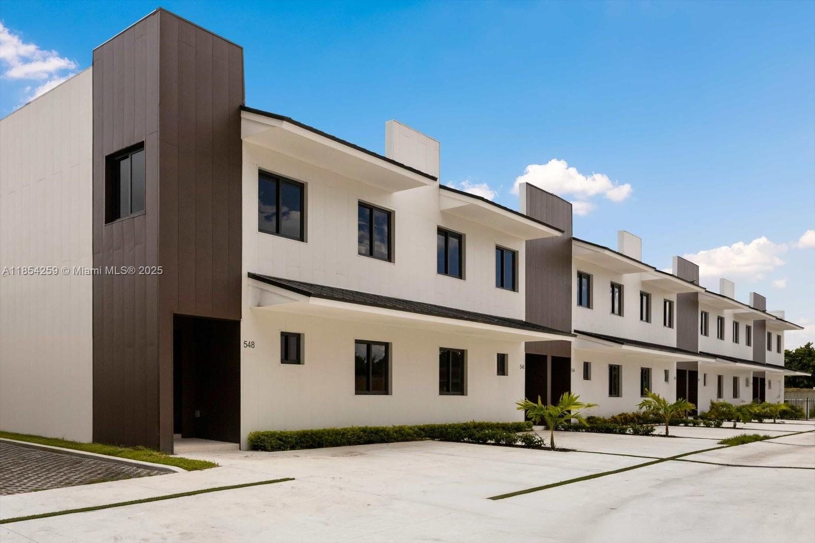 Front exterior of a new home in , Florida City, FL, highlighting curb appeal (Image 1). Front exterior of a new home in , Florida City, FL, highlighting curb appeal (Image 1).